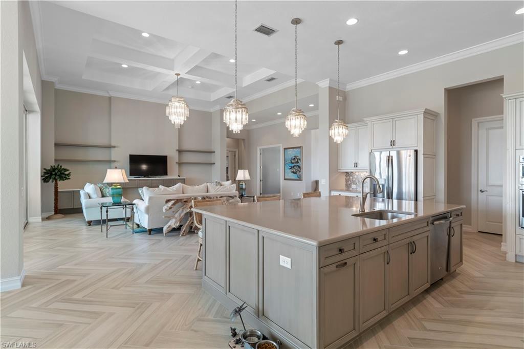 6254 Lightbourn Way Naples, FL 34113 - Photo 18 of 34 a large kitchen with lots of counter space and a sink