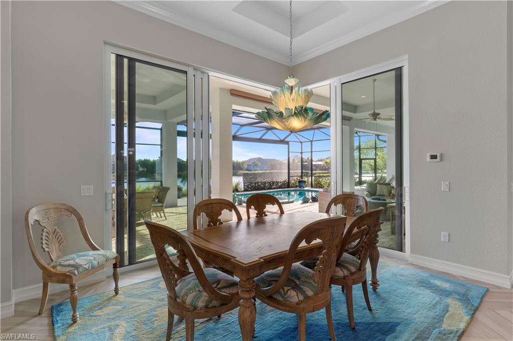 6254 Lightbourn Way Naples, FL 34113 - Photo 22 of 34 a view of a dining room with furniture wooden floor and chandelier