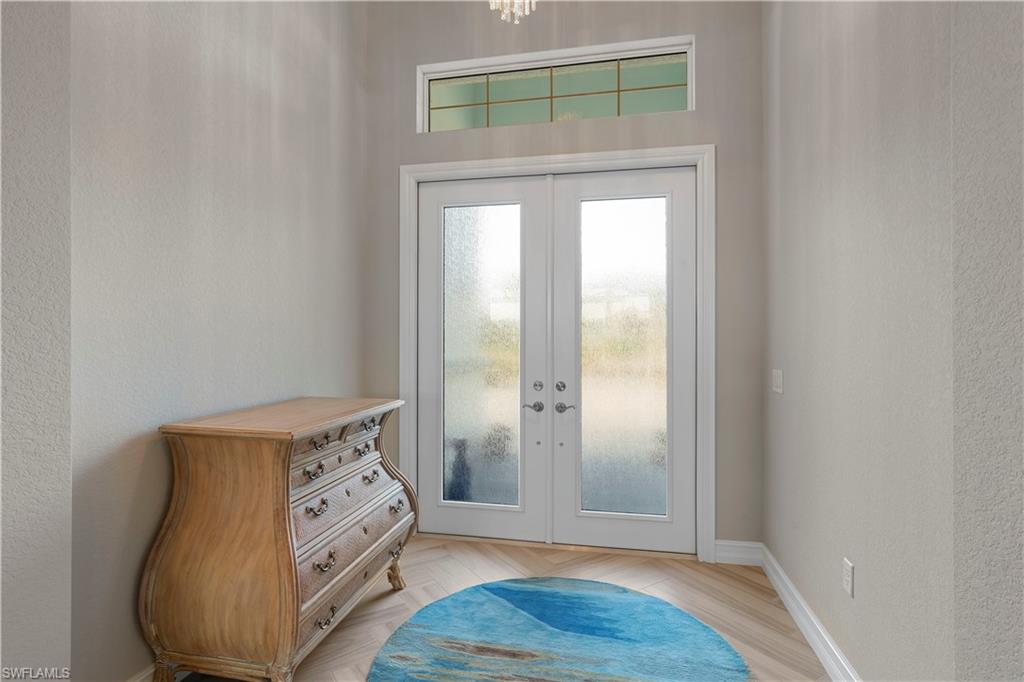 6254 Lightbourn Way Naples, FL 34113 - Photo 23 of 34 a view of front door with wooden floor