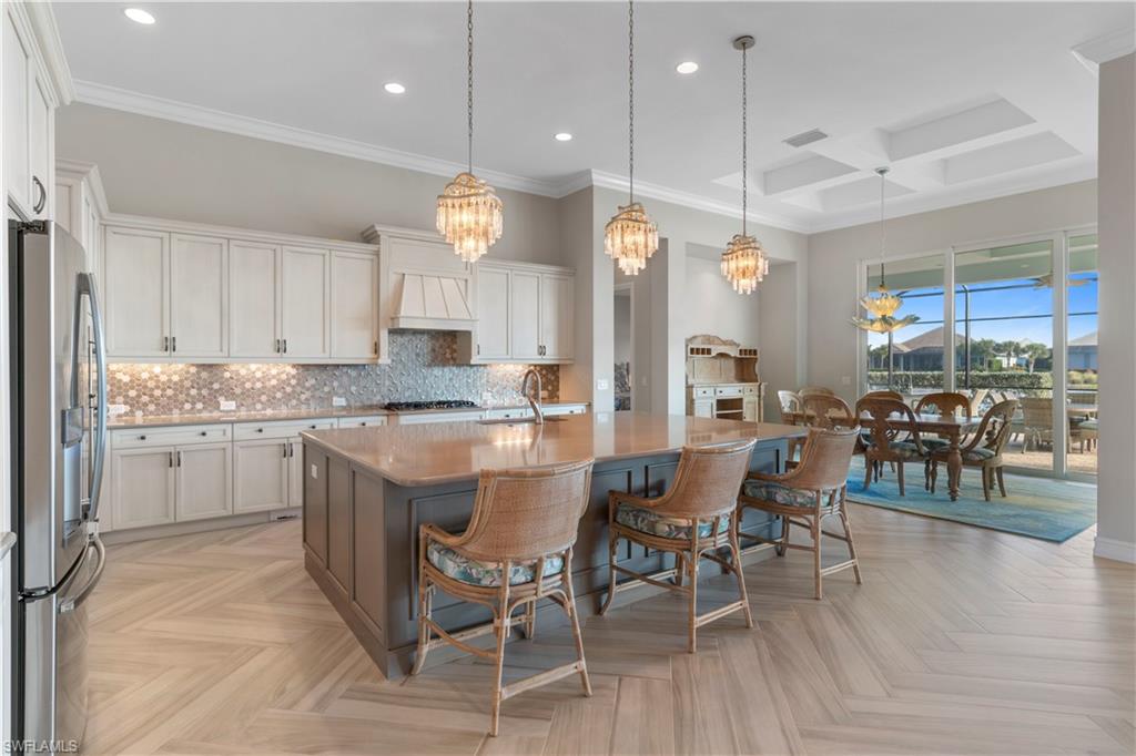 6254 Lightbourn Way Naples, FL 34113 - Photo 25 of 34 a large kitchen with a table and chairs