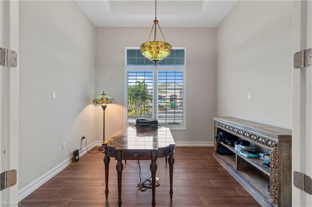 6254 Lightbourn Way Naples, FL 34113 - Photo 27 of 34 a view of a dining room with furniture window and wooden floor