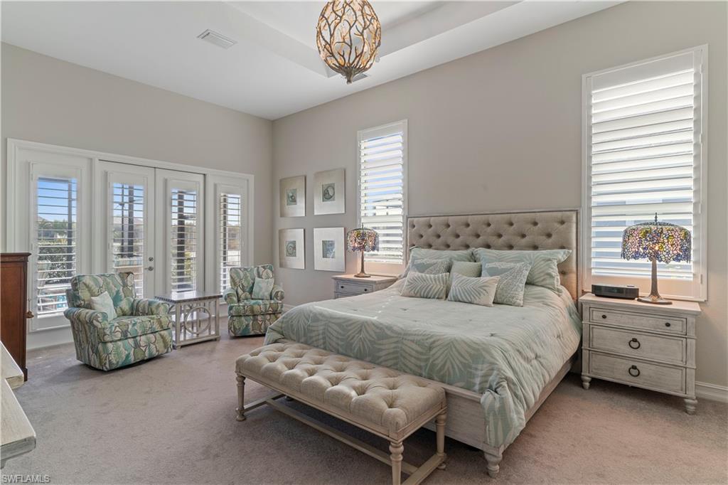 6254 Lightbourn Way Naples, FL 34113 - Photo 29 of 34 a bedroom with a bed and a couch next to a window