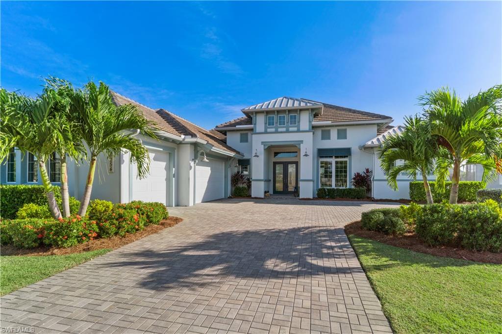 6254 Lightbourn Way Naples, FL 34113 - Photo 3 of 34 a front view of a house with a garden