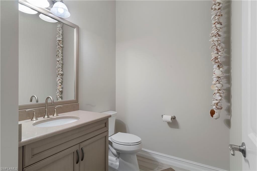 6254 Lightbourn Way Naples, FL 34113 - Photo 34 of 34 a bathroom with a sink a toilet and mirror