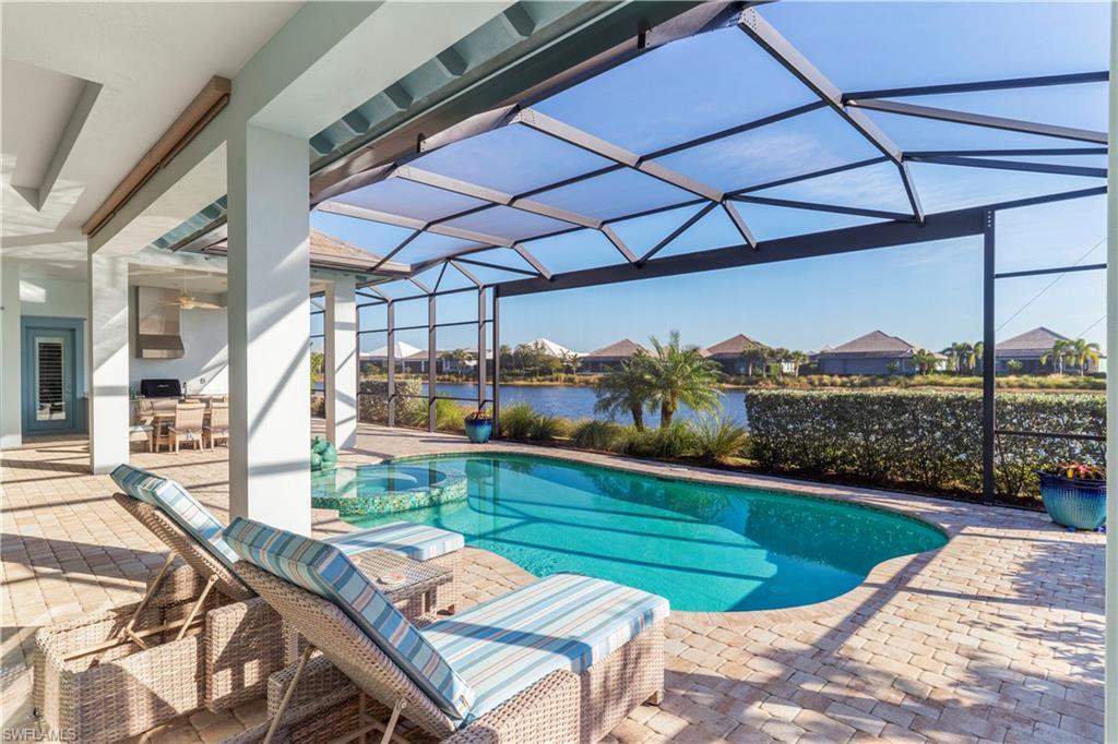 6254 Lightbourn Way Naples, FL 34113 - Photo 4 of 34 a view of a chairs and table in patio with a yard