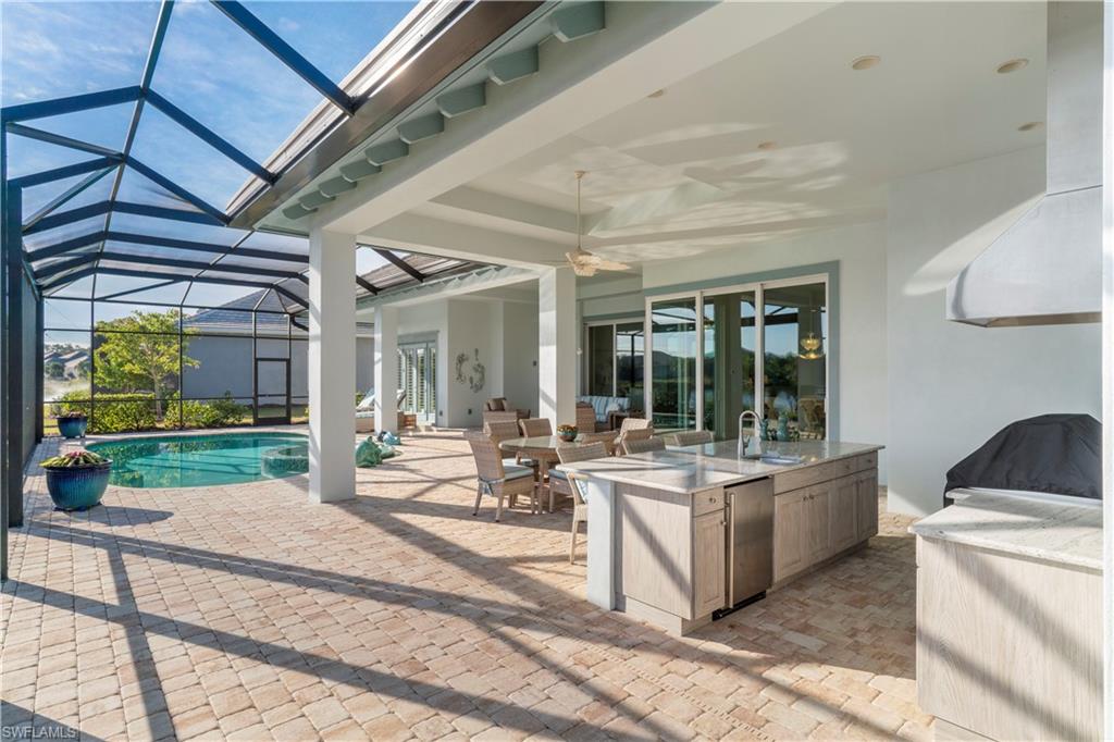 6254 Lightbourn Way Naples, FL 34113 - Photo 5 of 34 a living room with patio furniture and a floor to ceiling window