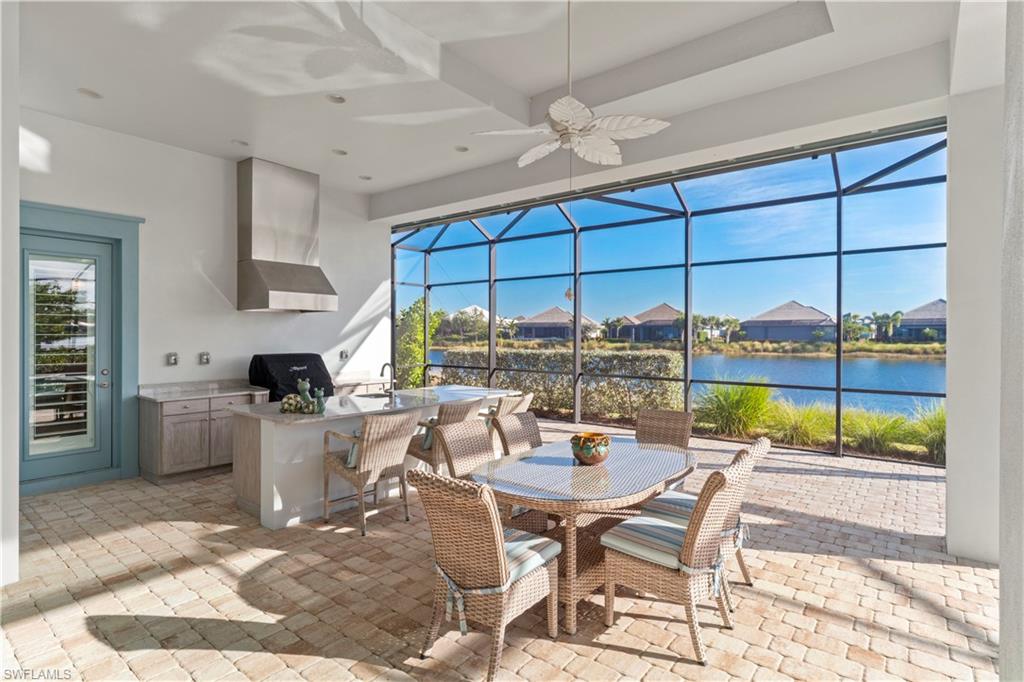6254 Lightbourn Way Naples, FL 34113 - Photo 7 of 34 a view of a dining room with furniture a chandelier and wooden floor