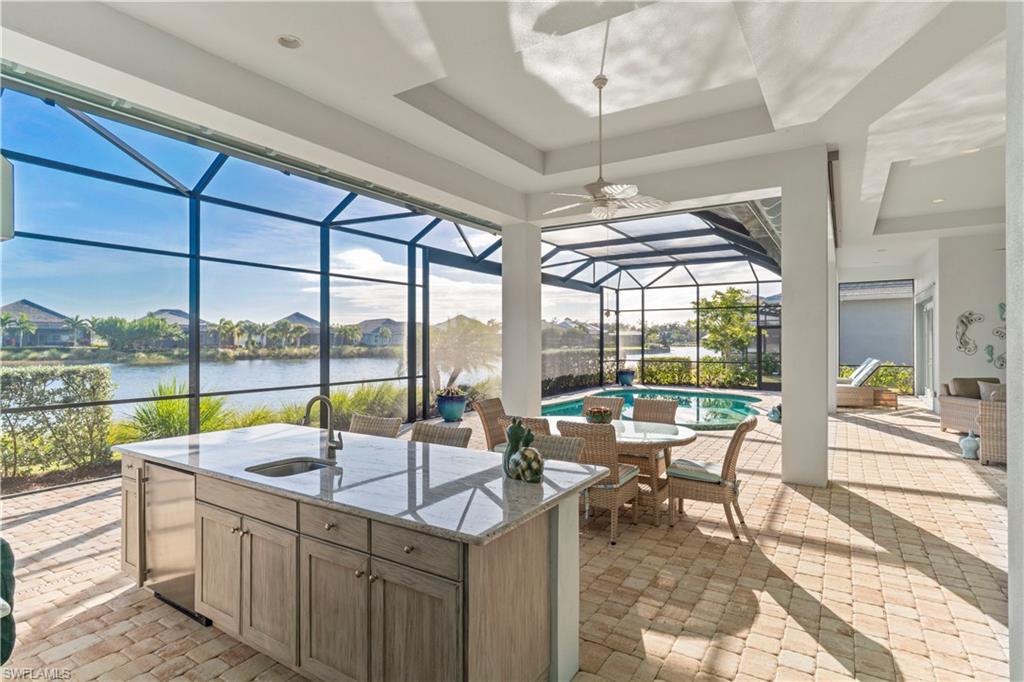 6254 Lightbourn Way Naples, FL 34113 - Photo 8 of 34 a view of a swimming pool with outdoor seating