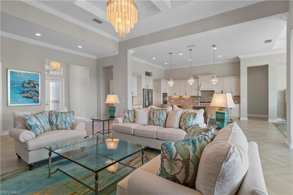 6254 Lightbourn Way Naples, FL 34113 - Photo 9 of 34 a living room with furniture and a chandelier