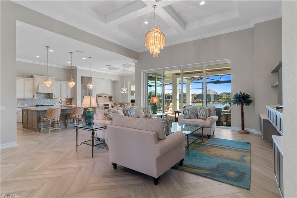 6254 Lightbourn Way Naples, FL 34113 - Photo 10 of 34 a living room with fireplace furniture and a chandelier