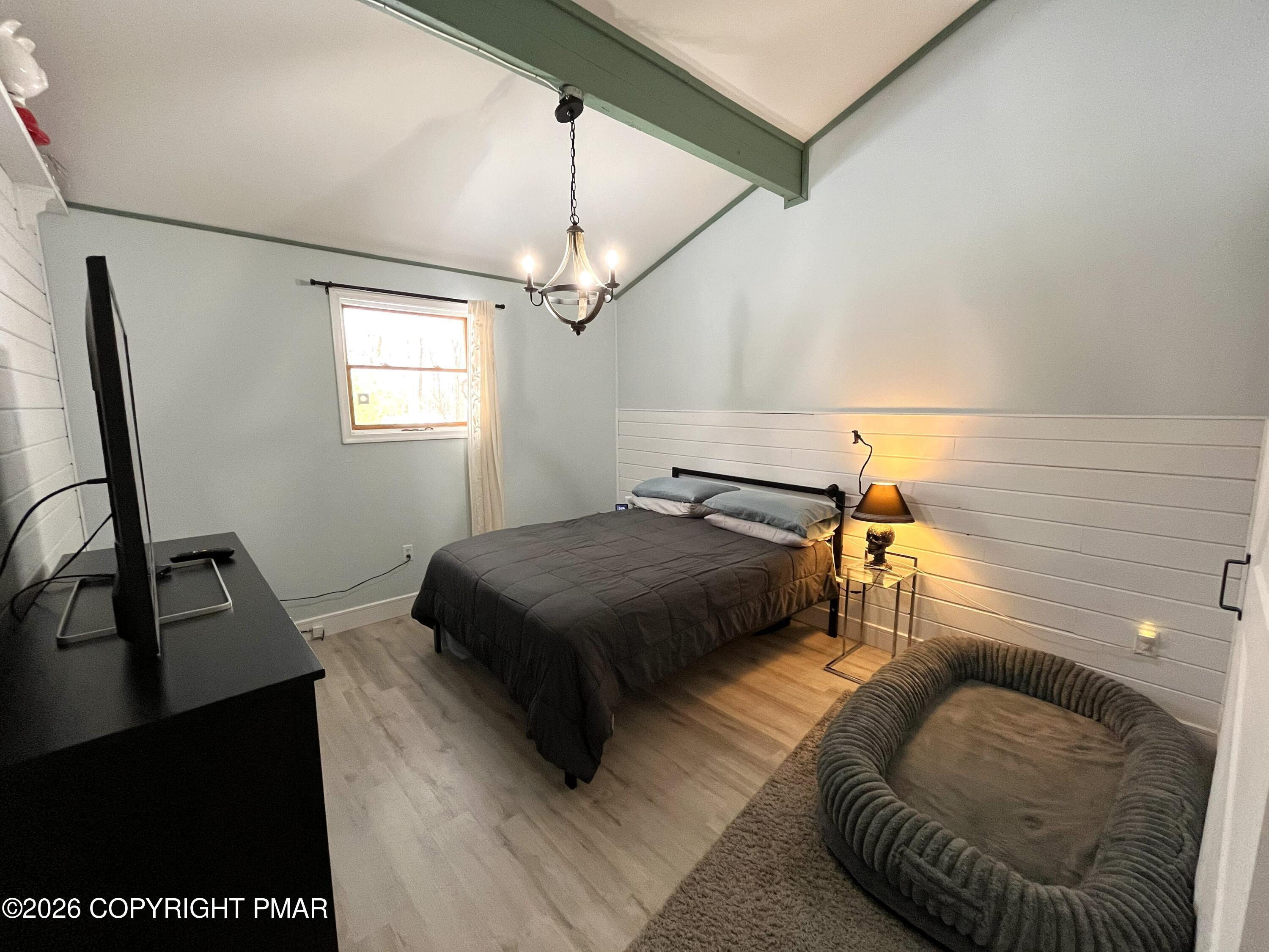 29 Hopi Road Jim Thorpe, PA 18229 - Photo 26 of 44 a bedroom with a bed a couch and a flat tv screen on a table