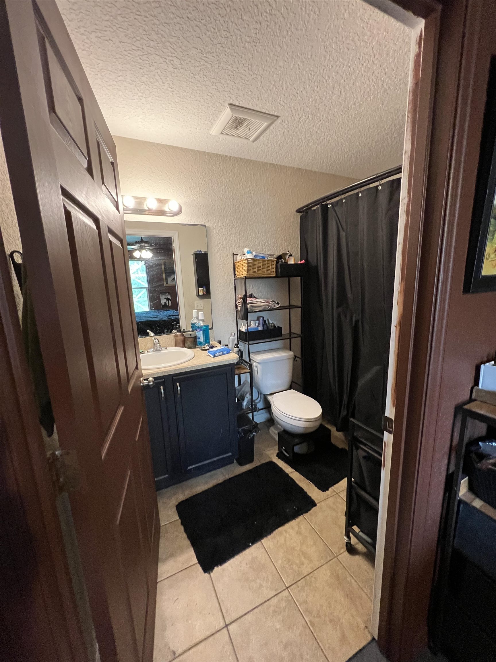921 Avery Street St. Augustine, FL 32084 - Photo 21 of 29 a bathroom with a sink a toilet a mirror and shower