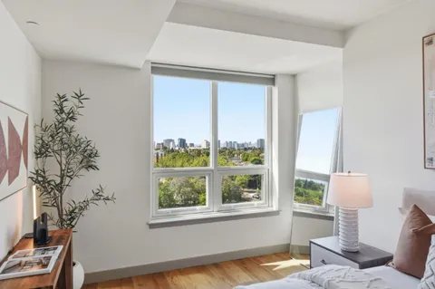 a bedroom with a bed and a potted plant