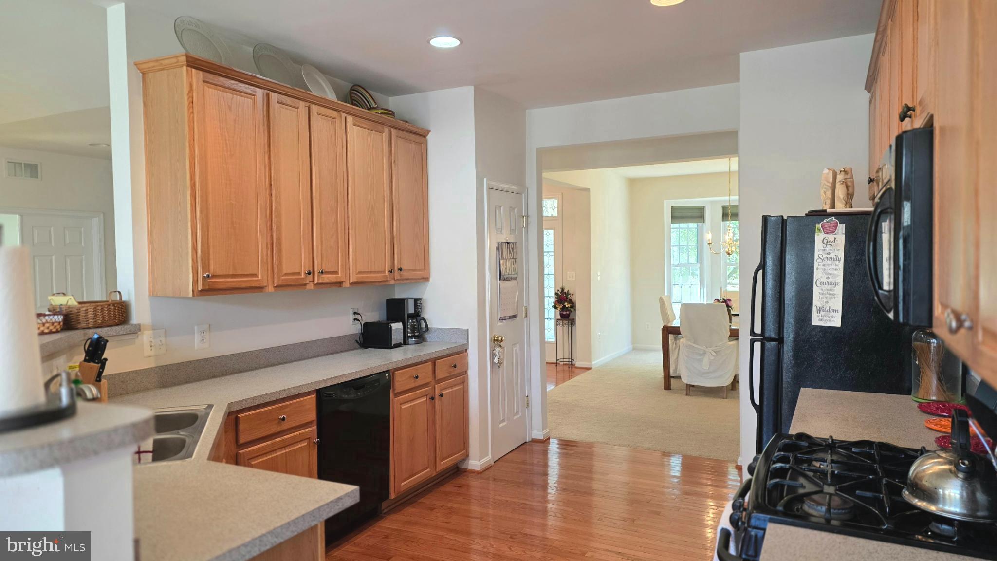 638 Hunters Road Culpeper, VA 22701 - Photo 5 of 46 a kitchen with stainless steel appliances granite countertop a refrigerator a sink dishwasher stove and white countertops with wooden floor