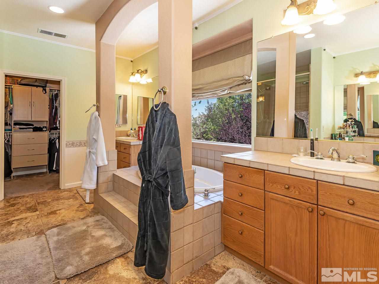 9175 Hummer Drive Reno, NV 89521 - Photo 20 of 26 a spacious bathroom with a double vanity sink and a mirror