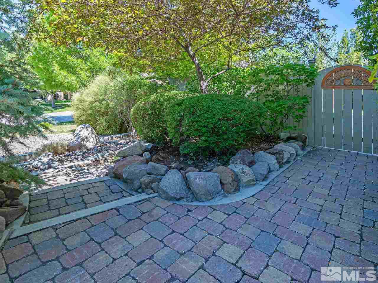 9175 Hummer Drive Reno, NV 89521 - Photo 3 of 26 a view of a yard with plants and large trees