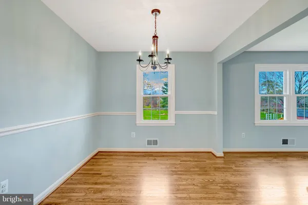 a view of an empty room with window and cabinet