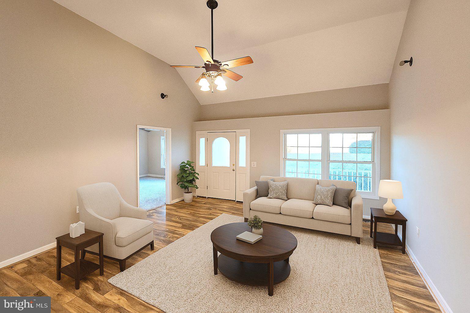 11219 Station Road Worton, MD 21678 - Photo 18 of 21 a living room with furniture a chandelier and a rug