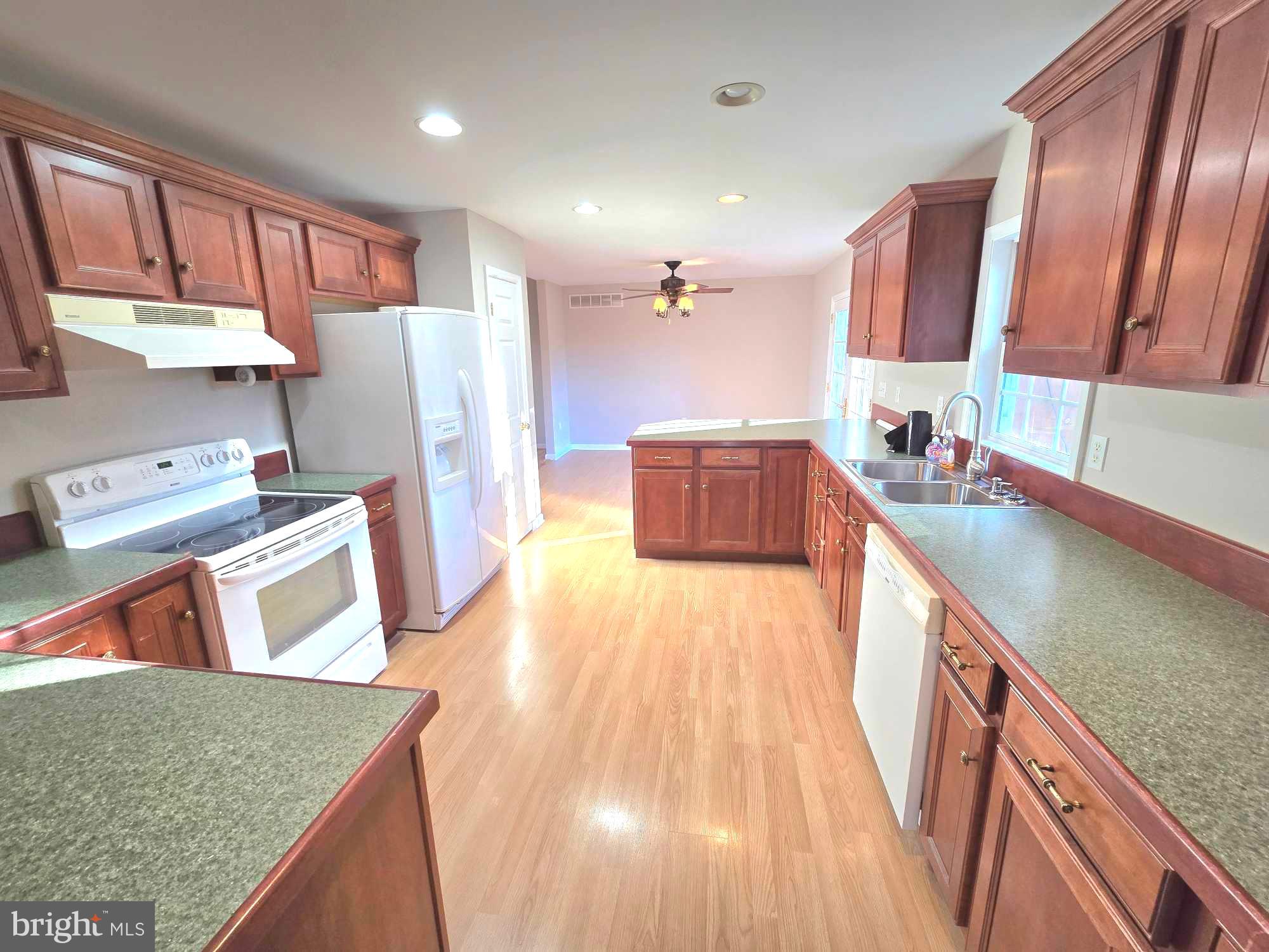 11219 Station Road Worton, MD 21678 - Photo 7 of 21 a kitchen with stainless steel appliances granite countertop a sink stove and refrigerator
