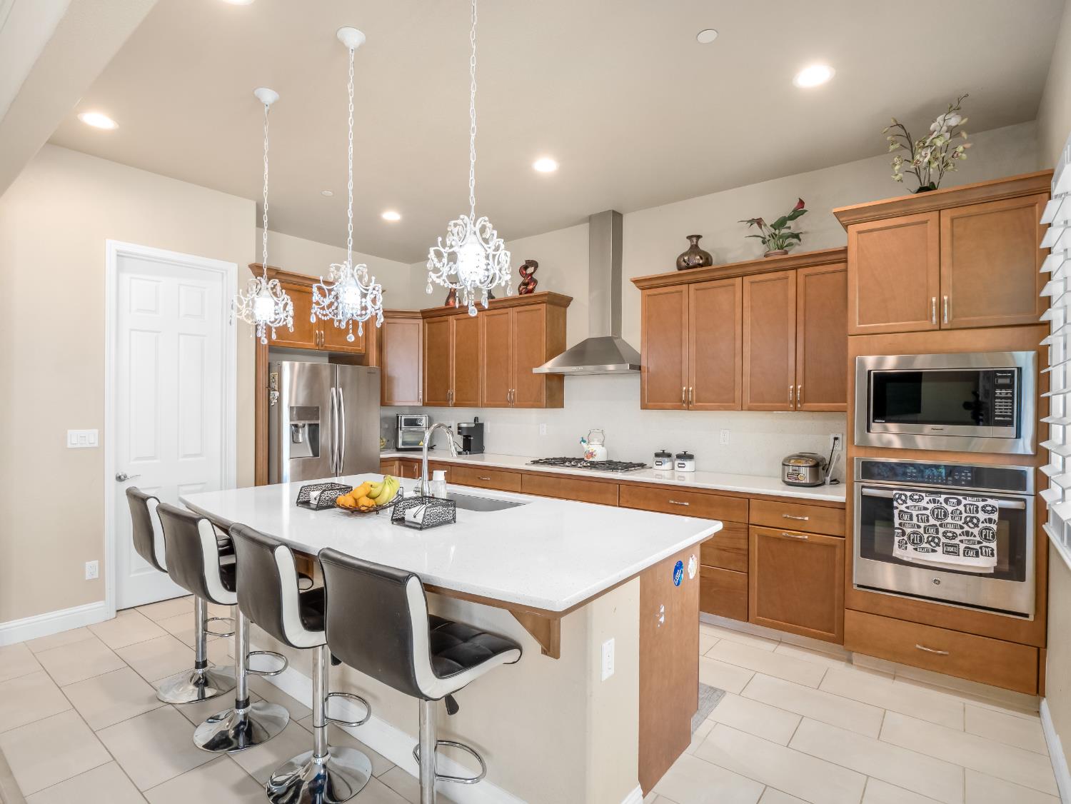 2127 Chennault Avenue Clovis, CA 93611 - Photo 13 of 49 a kitchen with stainless steel appliances granite countertop a stove a sink a microwave a refrigerator and cabinets