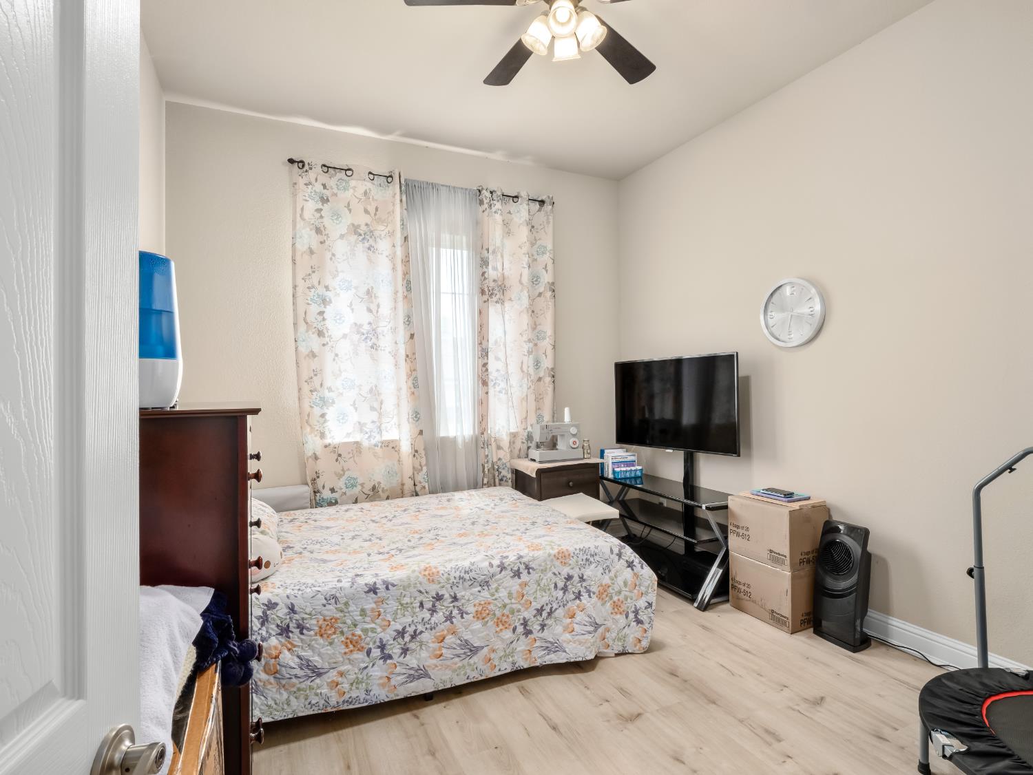 2127 Chennault Avenue Clovis, CA 93611 - Photo 21 of 49 a bedroom with a bed window and a flat screen tv