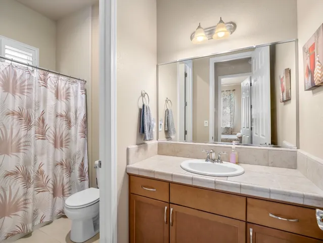a white toilet sitting next to a shower curtain