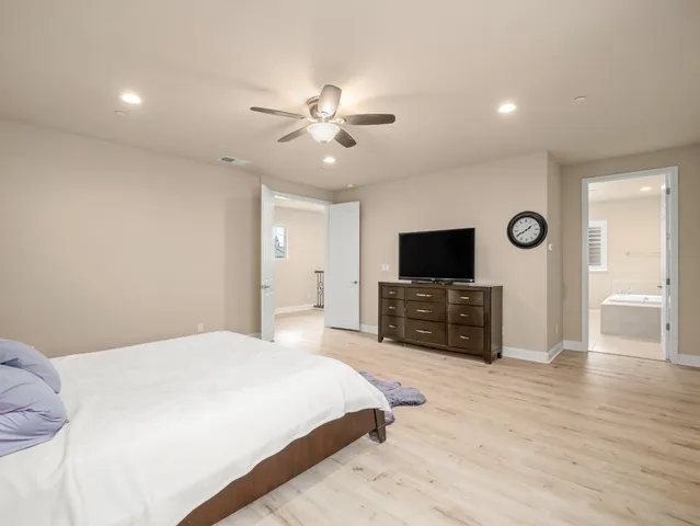 a large kitchen with stainless steel appliances kitchen island granite countertop a sink and a refrigerator