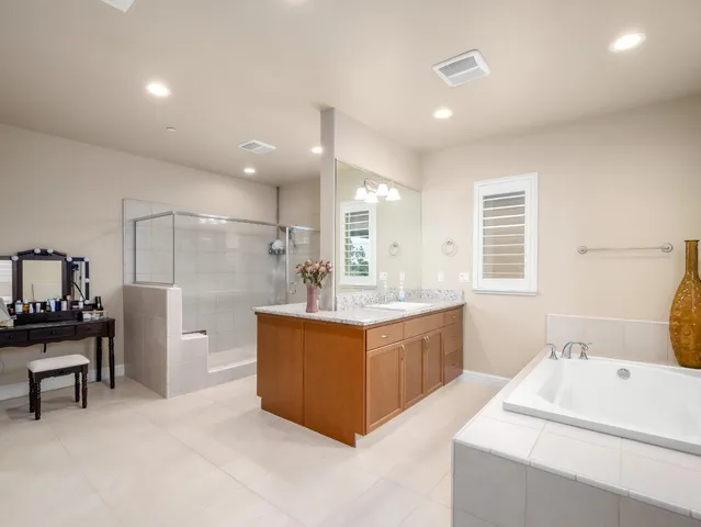 a bathroom with a tub sink and mirror