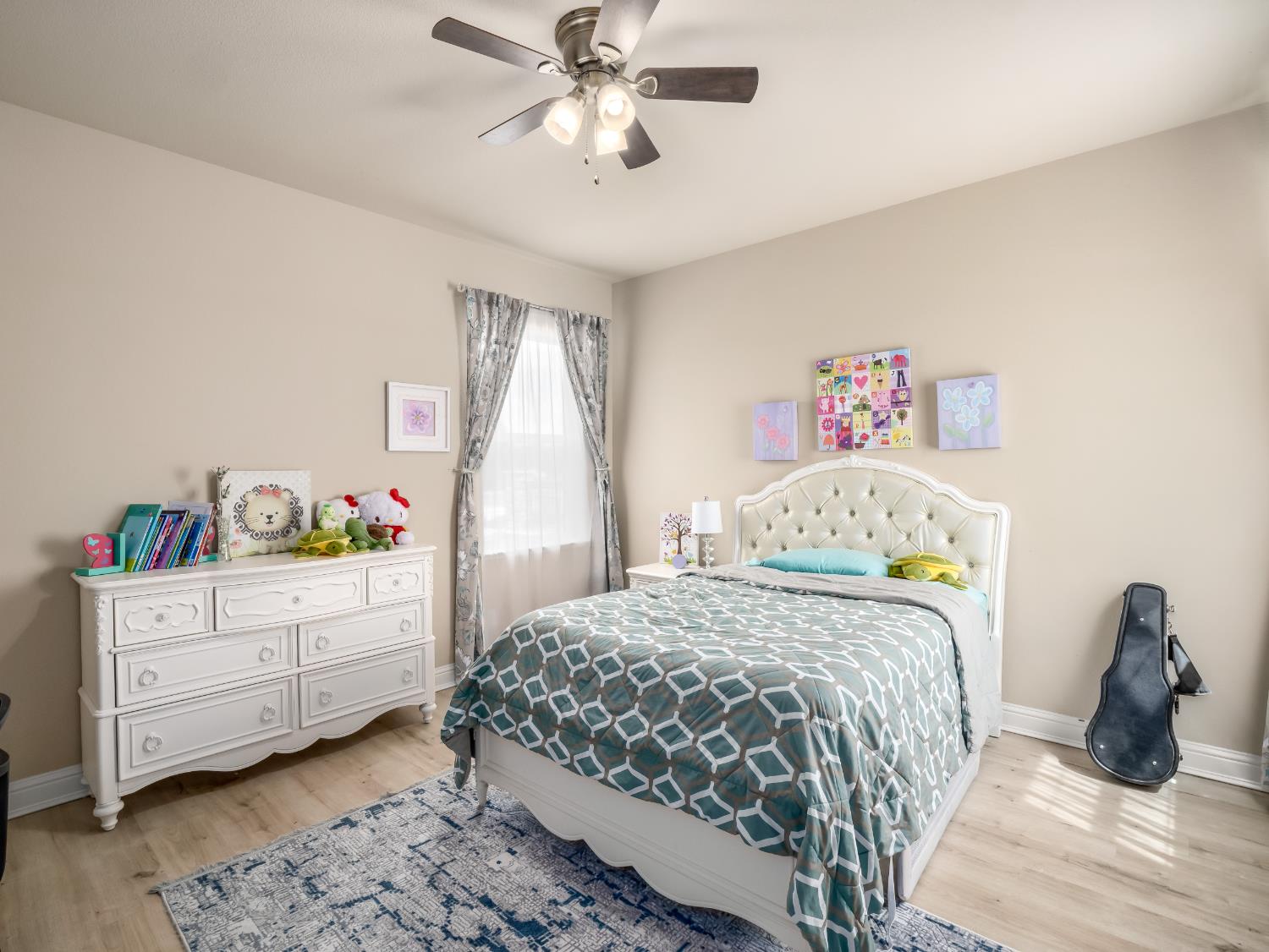 2127 Chennault Avenue Clovis, CA 93611 - Photo 35 of 49 a bedroom with a bed and a chandelier