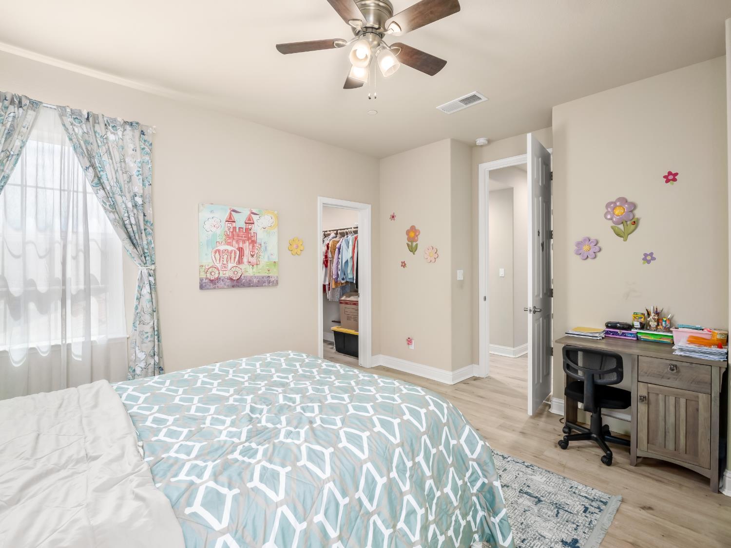 2127 Chennault Avenue Clovis, CA 93611 - Photo 36 of 49 a bedroom with a bed and a chandelier