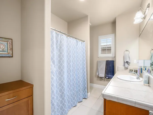 a bathroom with a sink a vanity and a mirror