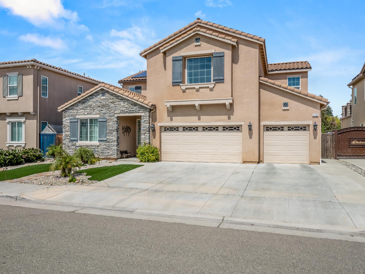 2127 Chennault Avenue Clovis, CA 93611 - Photo 4 of 49 a front view of a house with a yard and garage