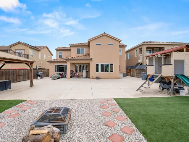 a front view of a house with a garden and sitting area