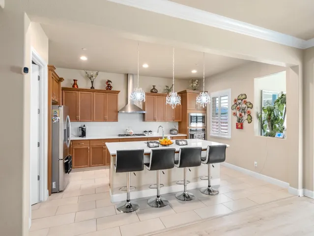 a kitchen with a stove a sink and a refrigerator