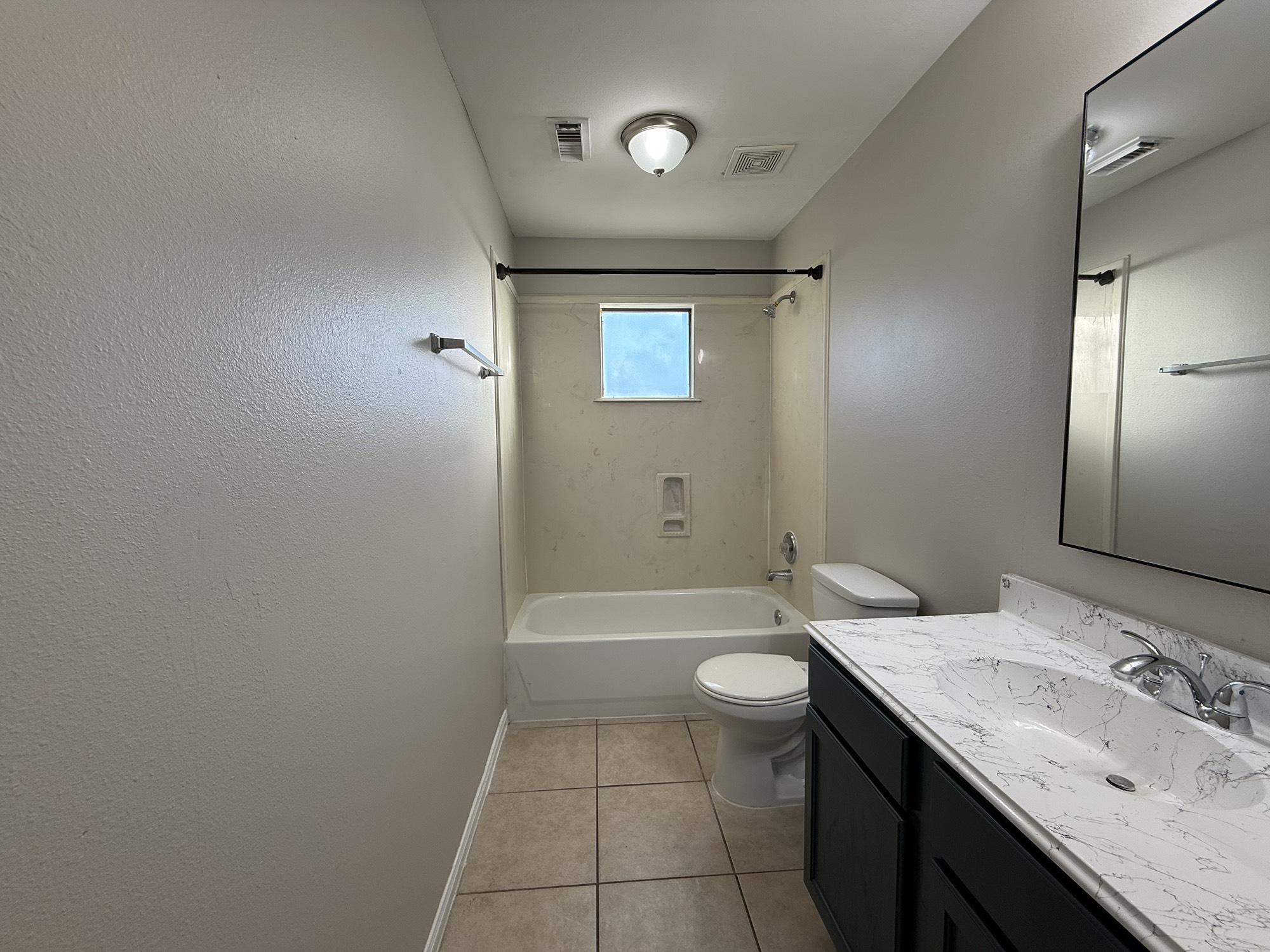 3032 La Estancia Lane Houston, TX 77093 - Photo 26 of 30 a bathroom with a granite countertop sink a toilet and shower