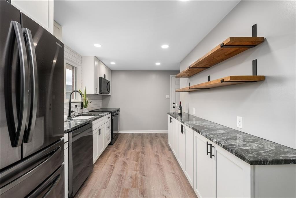 1384 Harmony Road Baden, PA 15005 - Photo 8 of 49 a kitchen with stainless steel appliances granite countertop a sink and a refrigerator