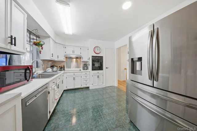 a kitchen with stainless steel appliances a refrigerator and a stove