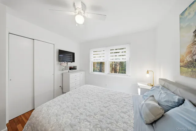 a bedroom with a bed dresser and a window