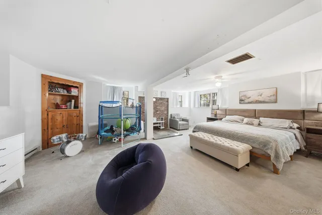 a spacious bedroom with a bed and gym equipment