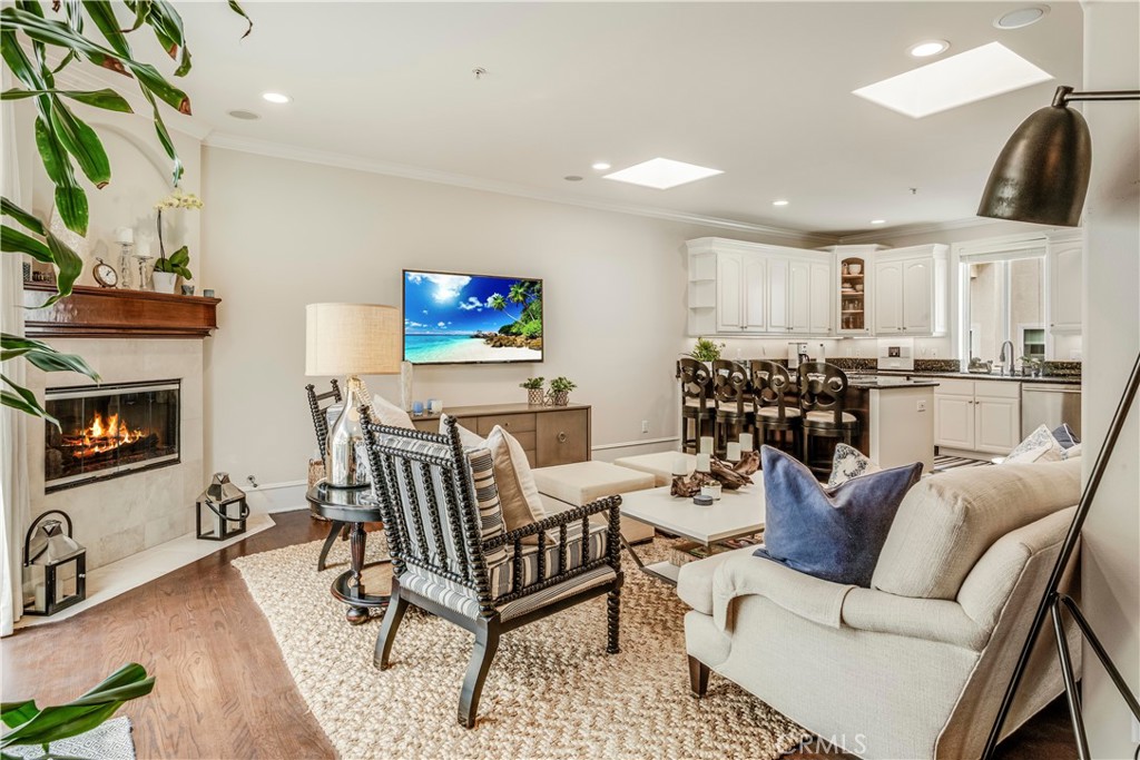 520 Esplanade, Unit D Redondo Beach, CA 90277 - Photo 13 of 24 a living room with furniture a flat screen tv and a fireplace