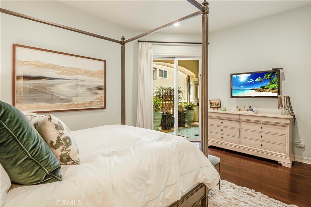 520 Esplanade, Unit D Redondo Beach, CA 90277 - Photo 16 of 24 a bedroom with a bed and a flat screen tv