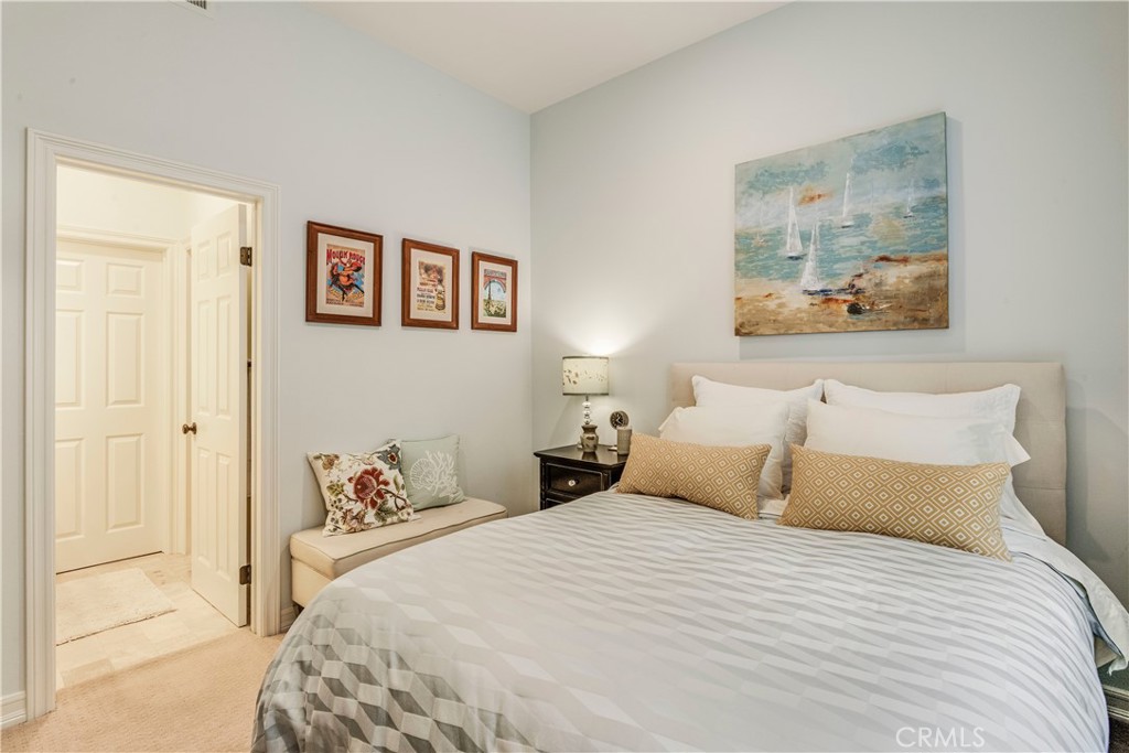 520 Esplanade, Unit D Redondo Beach, CA 90277 - Photo 21 of 24 a bedroom with a bed and a painting on the wall
