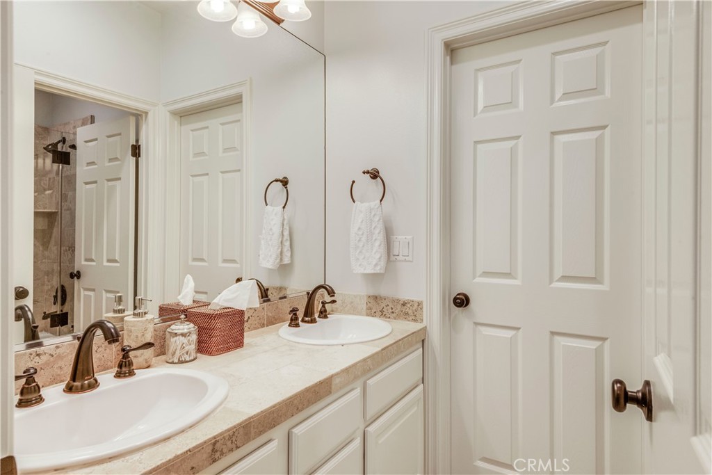 520 Esplanade, Unit D Redondo Beach, CA 90277 - Photo 22 of 24 a bathroom with double vanity sinks a mirror and a shower