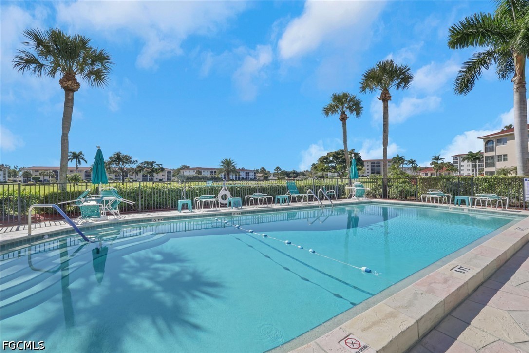 9 High Point Circle North, Unit 101 Naples, FL 34103 - Photo 35 of 49 a view of a swimming pool and a terrace