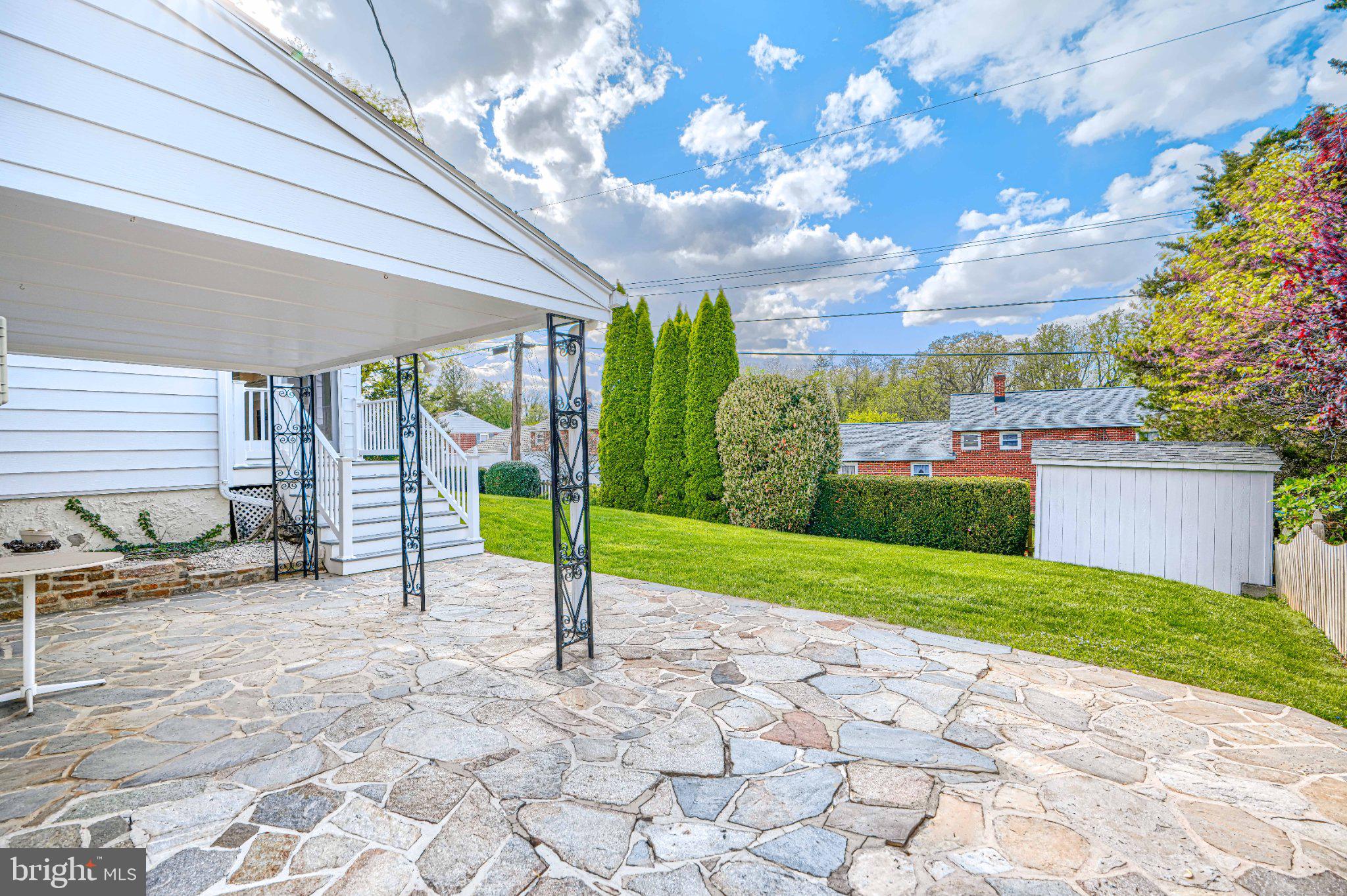8 Felton Road Lutherville-Timonium, MD 21093 - Photo 5 of 42 Sunny patio with lush green backdrop.