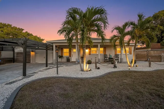 a view of a backyard with a patio and swimming pool