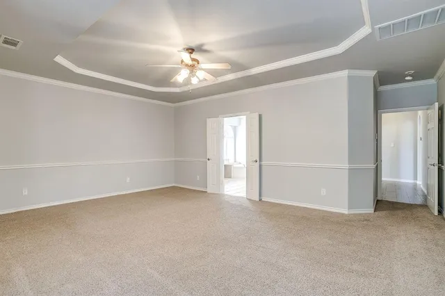 a view of an empty room with a ceiling fan