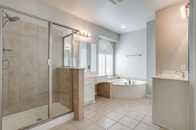 a bathroom with a bathtub and shower