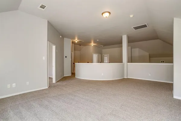 an empty room with large windows