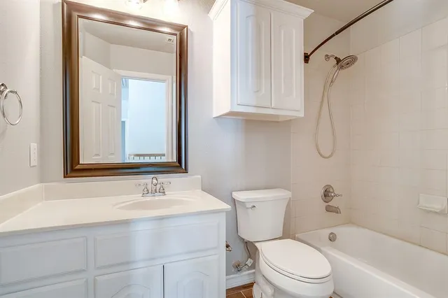 a bathroom with a sink vanity mirror and toilet